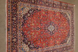 Kashan signed red ground rug, central medallion, repeating border,