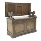 20th century oak monks bench, carved lion arms, two panel front, bracket supports, W101cm, H100cm,