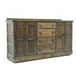 Medium oak sideboard, raised back, four graduating drawers flanked by four cupboards,