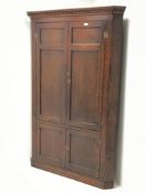 Late 18th century oak double corner cupboard,