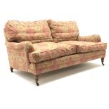 Quality three seat traditional style sofa upholstered in a dark gold and red patterned fabric,