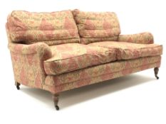 Quality three seat traditional style sofa upholstered in a dark gold and red patterned fabric,