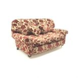 Two seat sofa, scrolled arms, upholstered in a patterned red and gold fabric,