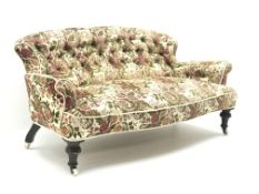 Small Victorian settee, deep buttoned beige ground upholstery with a floral pattern,