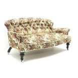 Small Victorian settee, deep buttoned beige ground upholstery with a floral pattern,