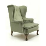 Early 20th century Queen Anne style wing back upholstered in a lime fabric,