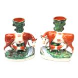 Pair Victorian Staffordshire spill vases each surmounted with the model of a cow and suckling calf,
