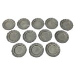 Set of twelve 19th century miniature pewter plates with waved rim,