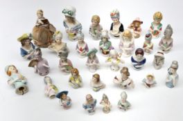 Group of thirty half pin cushion dolls of varying sizes, one with pin cushion base,