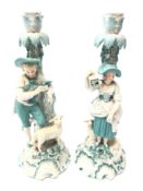 Pair 19th century porcelain candlesticks modelled as a male and female leaning against a tree