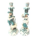 Pair 19th century porcelain candlesticks modelled as a male and female leaning against a tree