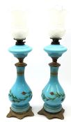 Pair of early 20th century blue opaque glass oil lamps,
