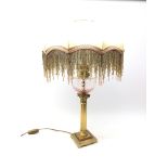Modern Corinthian Column oil lamp style table lamp, the silk shade having beaded fringing,
