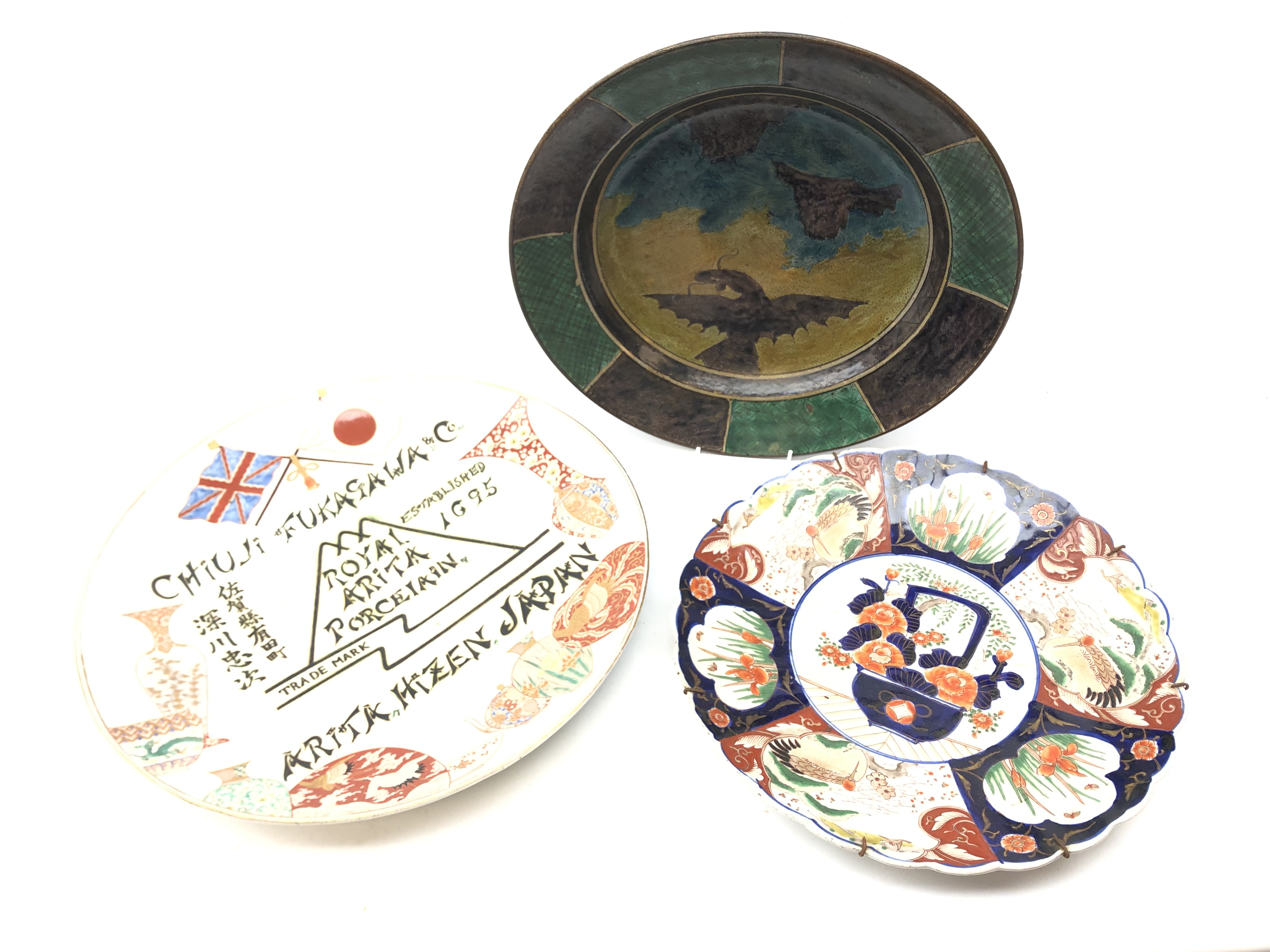 Japanese Meiji period charger hand-painted with a Dragon flying above crashing waves, D36cm,