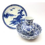 Early 20th century Japanese blue and white charger decorated with cranes in a mountainous landscape