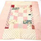 Victorian patchwork quilt, using printed cottons in pinks, purples, reds,