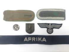 WW2 German badges and insignia including officer's tunic eagle, Afrika cuff title,