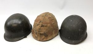 WW2 American M1 Steel helmet, with camouflauged cover, another with net, interior marked F.Ae/LM J.