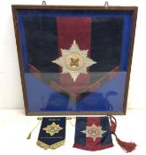 A framed Irish Guards music stand banner with woven badge 61cm x 59cm,