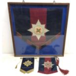 A framed Irish Guards music stand banner with woven badge 61cm x 59cm,