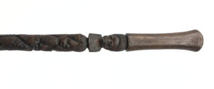 Carved hardwood tribal walking stick, shaft carved with figures and with tapering handle,