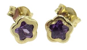 Pair of gold amethyst star stud earrings,