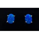 Pair of silver oval opal stud earrings,