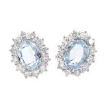 Pair of 18ct white gold aquamarine and diamond cluster earrings hallmarked,