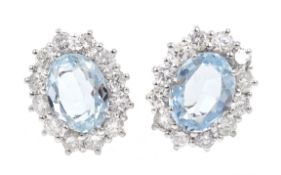 Pair of 18ct white gold aquamarine and diamond cluster earrings hallmarked,