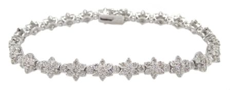 White gold flower design line bracelet, stamped 18K, total diamond weight 5.