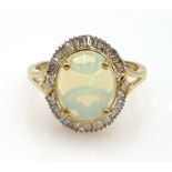 Gold oval opal baguette cut diamond cluster ring,