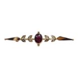 Gold garnet and seed pearl brooch stamped 9ct