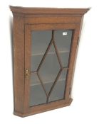 Georgian oak hanging corner cabinet, single glazed door enclosing two shelves, W69cm, H99cm,