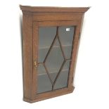 Georgian oak hanging corner cabinet, single glazed door enclosing two shelves, W69cm, H99cm,