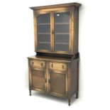 20th century oak side cabinet with glazed top above two drawers and two doors on turned supports,