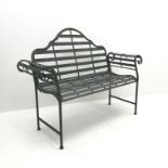 Wrought metal rustic grey garden bench with curved arms and shaped back,