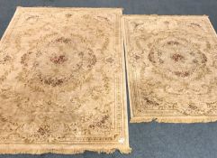 Pair graduating Persian style gold ground rugs central medallion, repeating border,