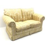Duresta small two seat traditional sofa, upholstered in a gold floral patterned fabric,