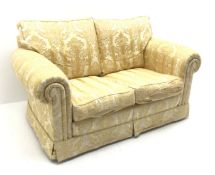 Duresta small two seat traditional sofa, upholstered in a gold floral patterned fabric,