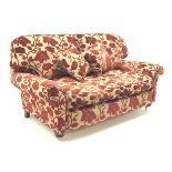Two seat sofa, scrolled arms, upholstered in a patterned red and gold fabric,