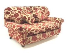 Two seat sofa, scrolled arms, upholstered in a patterned red and gold fabric,