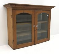 Early 20th century pine bookcase, two glazed doors enclosing two shelves, W123cm, H94cm,