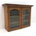 Early 20th century pine bookcase, two glazed doors enclosing two shelves, W123cm, H94cm,