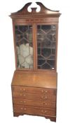 Edwardian inlaid mahogany bureau bookcase, broken swan neck pediment, two astragal glazed doors,