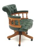 Captain's swivel chair upholstered in green buttoned leather on swivel base,