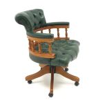 Captain's swivel chair upholstered in green buttoned leather on swivel base,