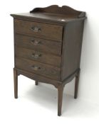 Early 20th century mahogany music cabinet, raised shaped back, four fall front drawers,