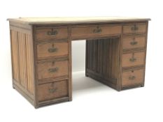 Edwardian oak twin pedestal desk, leather inset top, eight short and one long drawer, W122cm, H69cm,