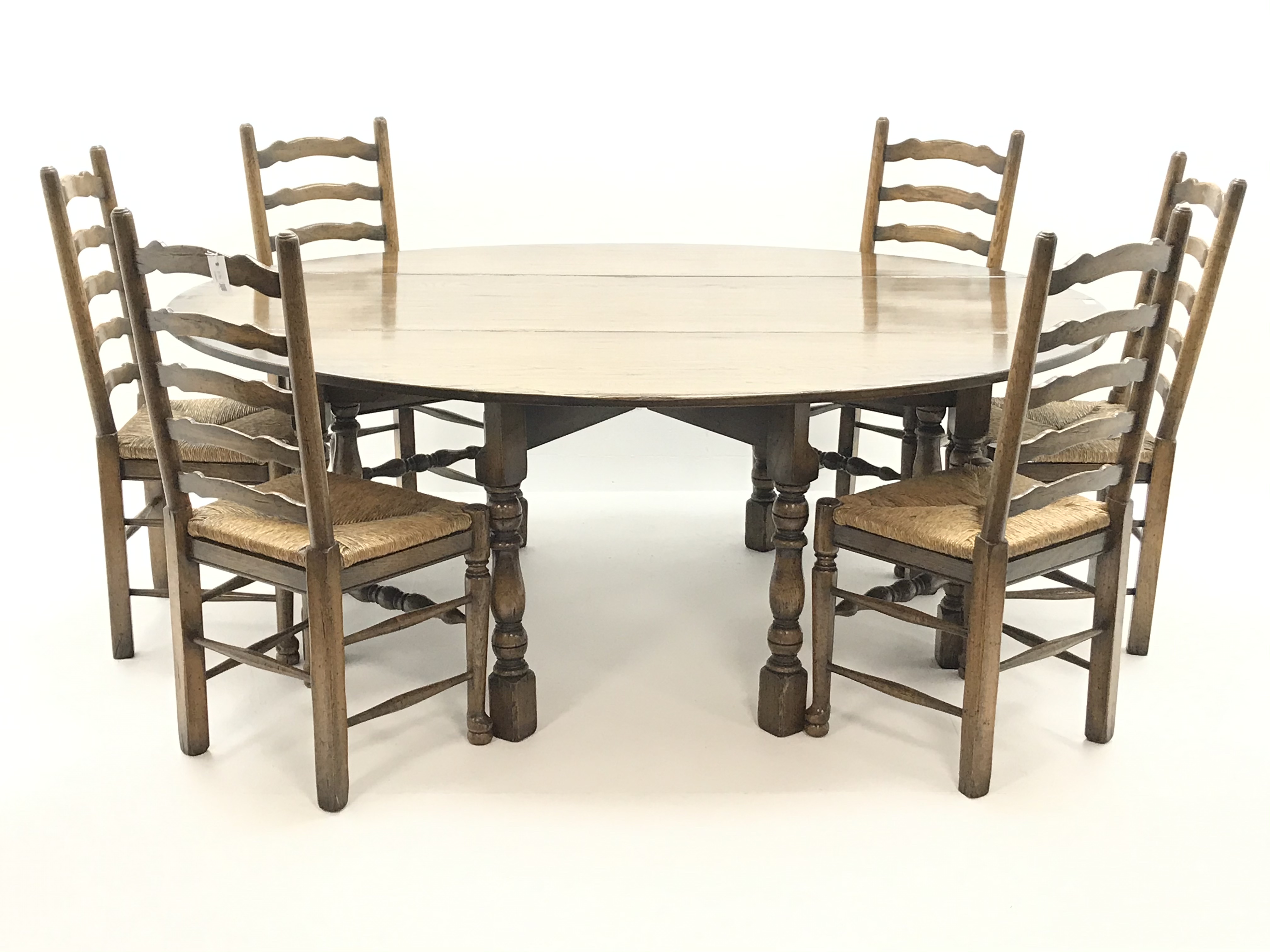 Medium oak oval drop leaf wake dining table on turned gate leg base (L198cm x W156cm,