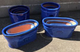 Five graduating glazed ceramic traditional cylinder pots,
